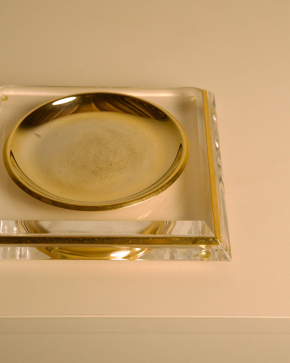 Italian "Pyramid" Trinket Dish in Brass and Plexiglass, 70s — angled view on neutral background
