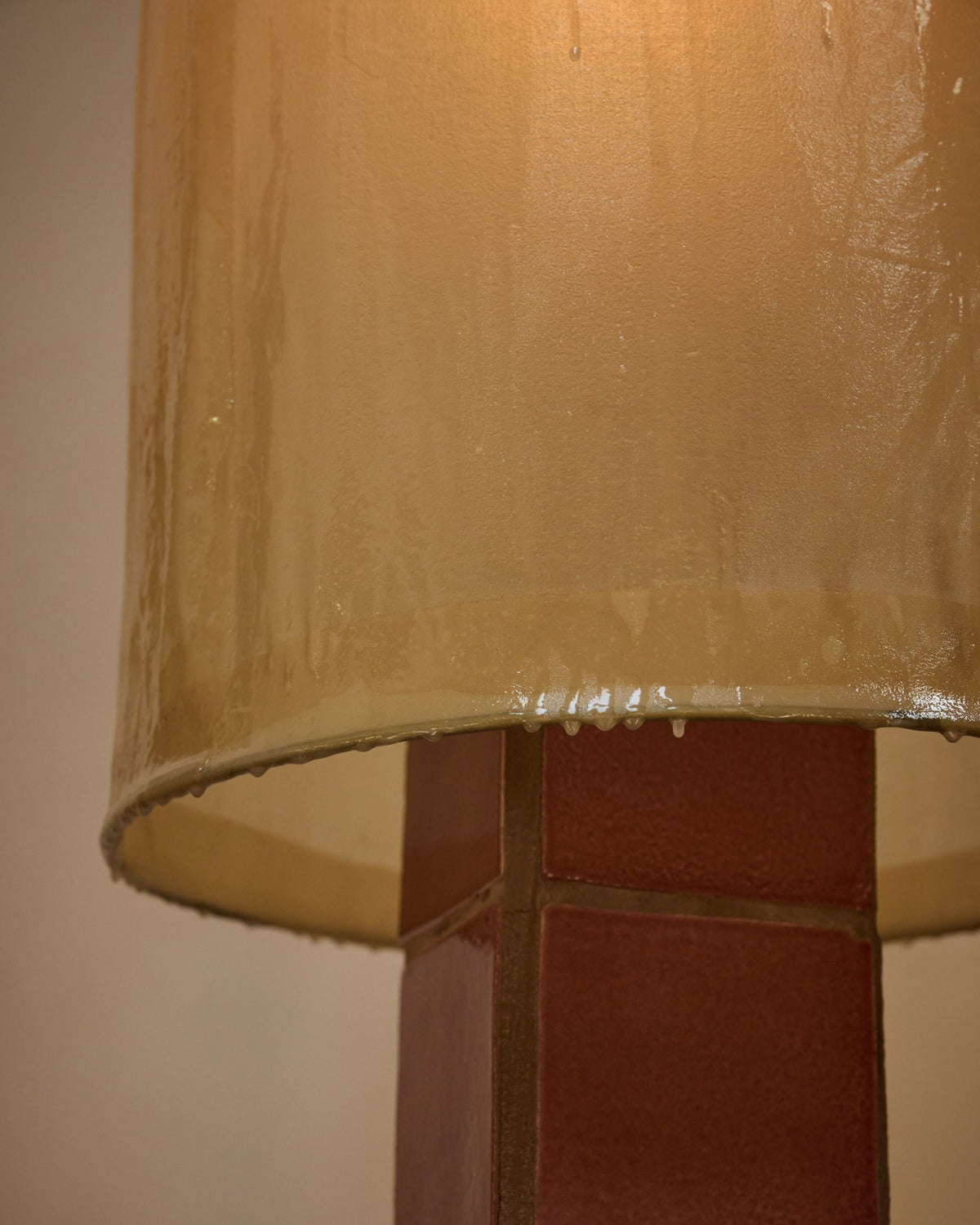 Close-up detail of Jura floor lamp's curved glass shade and base