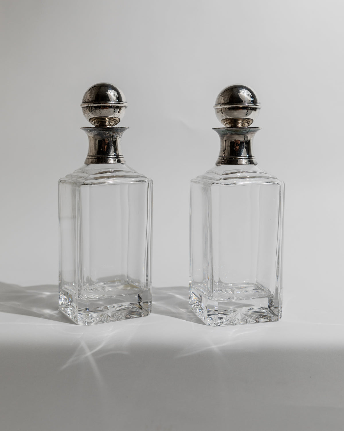 Pair of crystal decanters with silver tops from 1950s
