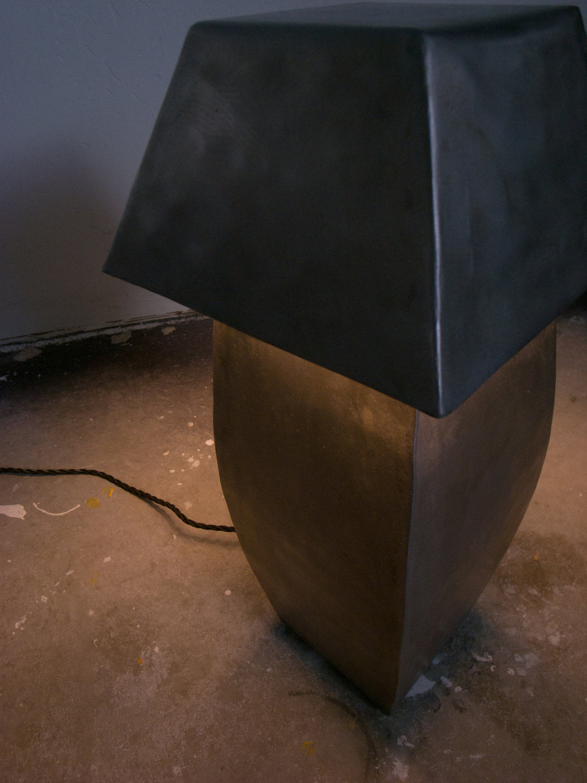 Tall hammered steel table lamp with geometric bronze base detail