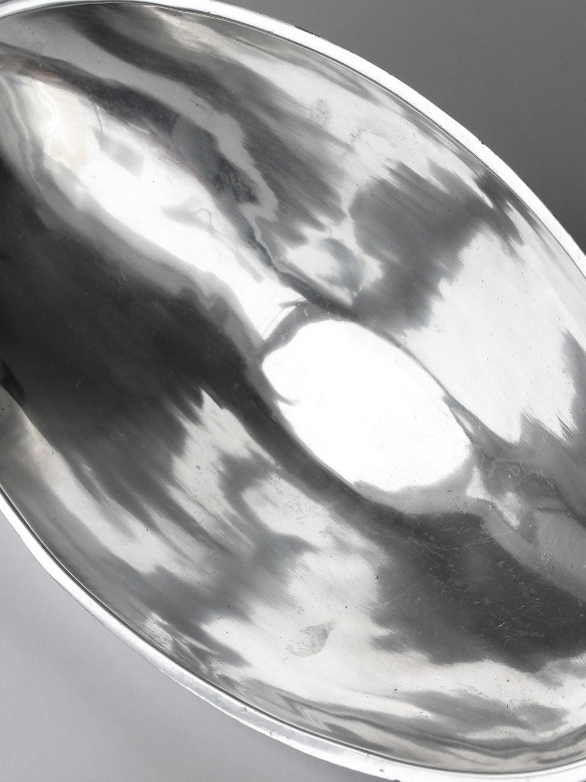 Polished aluminum bowl interior showing reflective curved surface