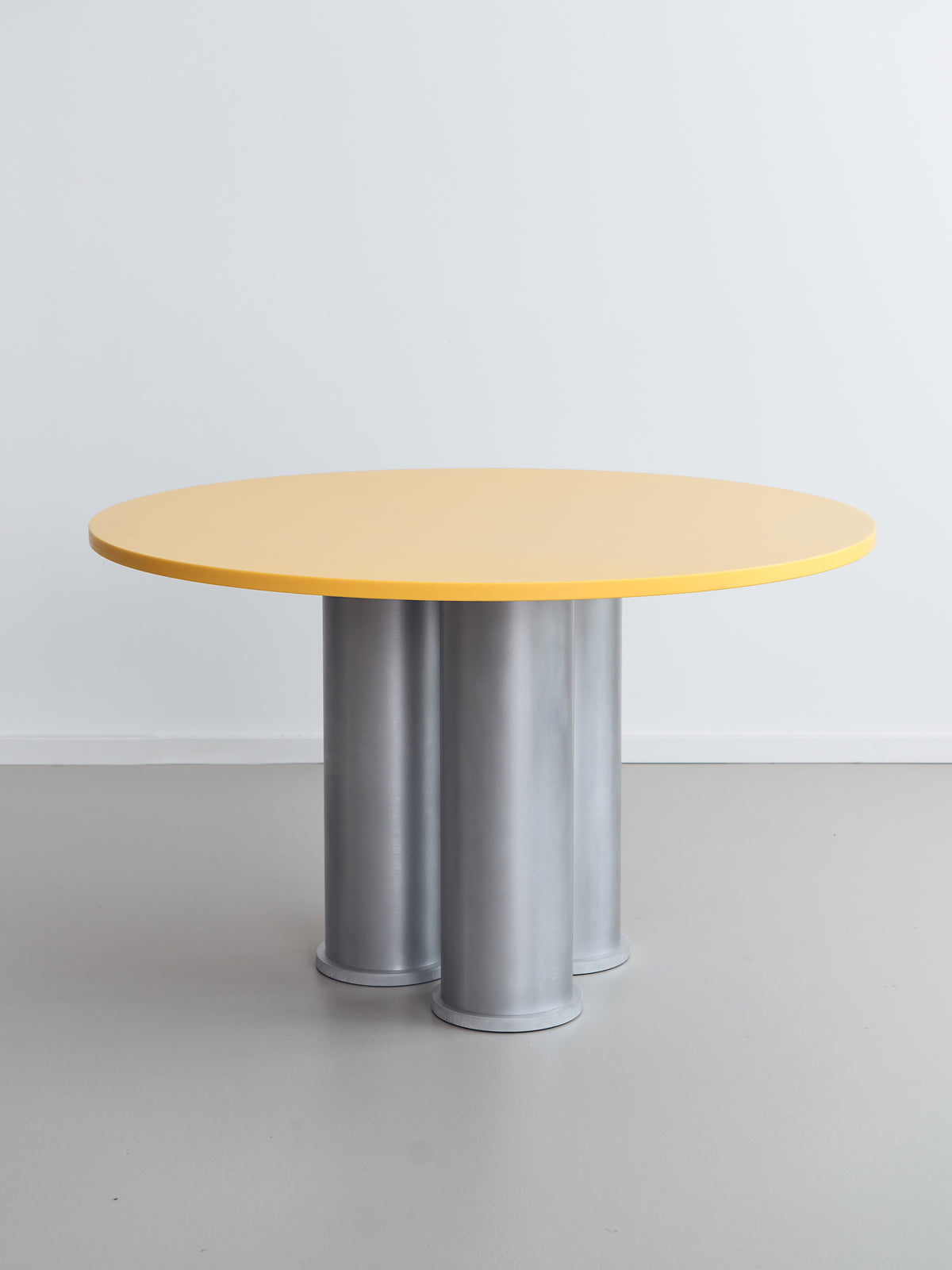 Elephant Table (Dining) — side angle showing yellow top and metal legs