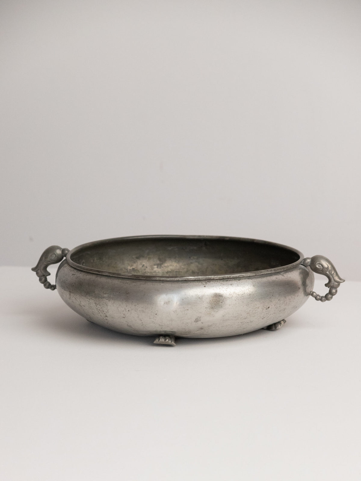 Footed Pewter Bowl with Bird or Dolphin Head Handles, Swedish Grace and Art Deco Idiom, 1930s — lifestyle setting
