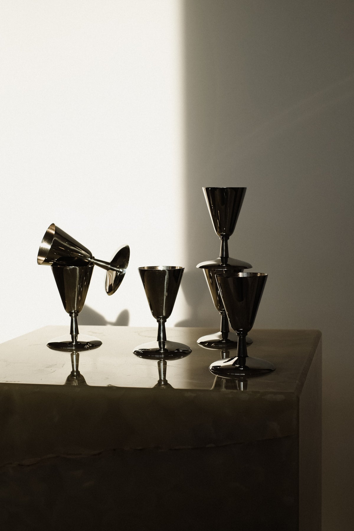 Set of 6 Coupes — top view of metallic glasses on marble surface