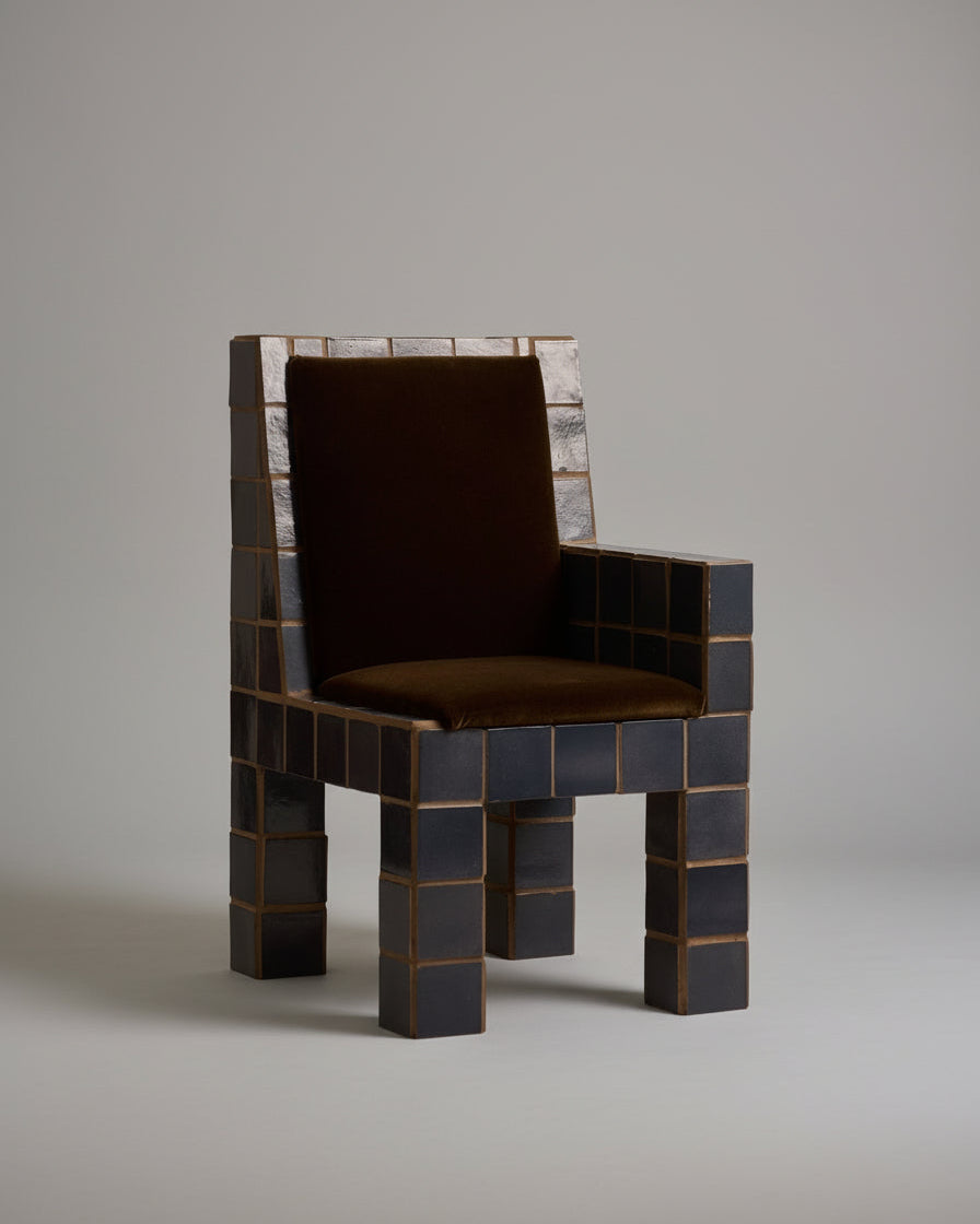 Jura tiled armchair with dark ceramic blocks and brown leather seat