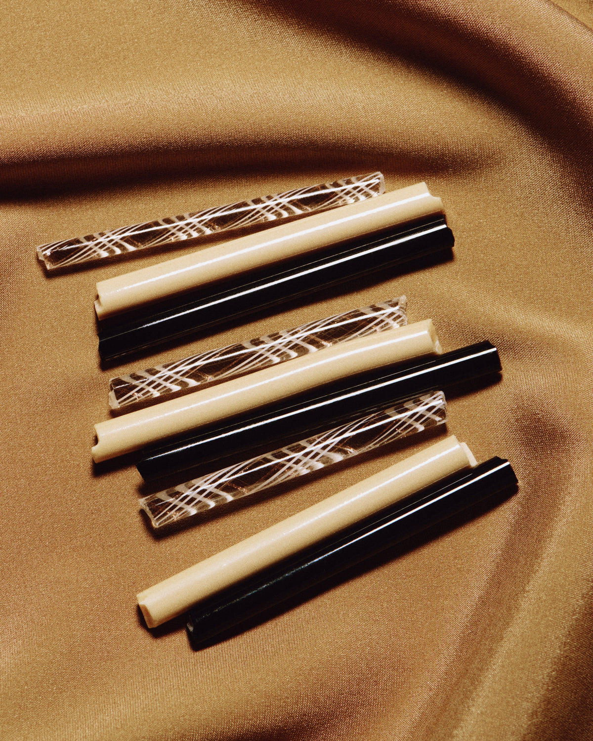 Clara Glasses - Set of four — close-up of patterned glass straws on fabric