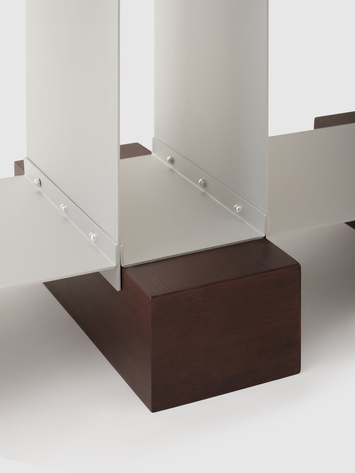 Detail view of Dado shelf glass panel connection to walnut base