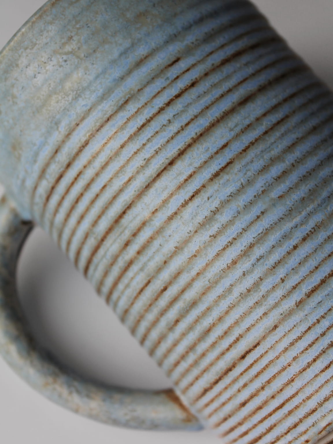 Ribbed ceramic surface detail of turquoise mid-century jug