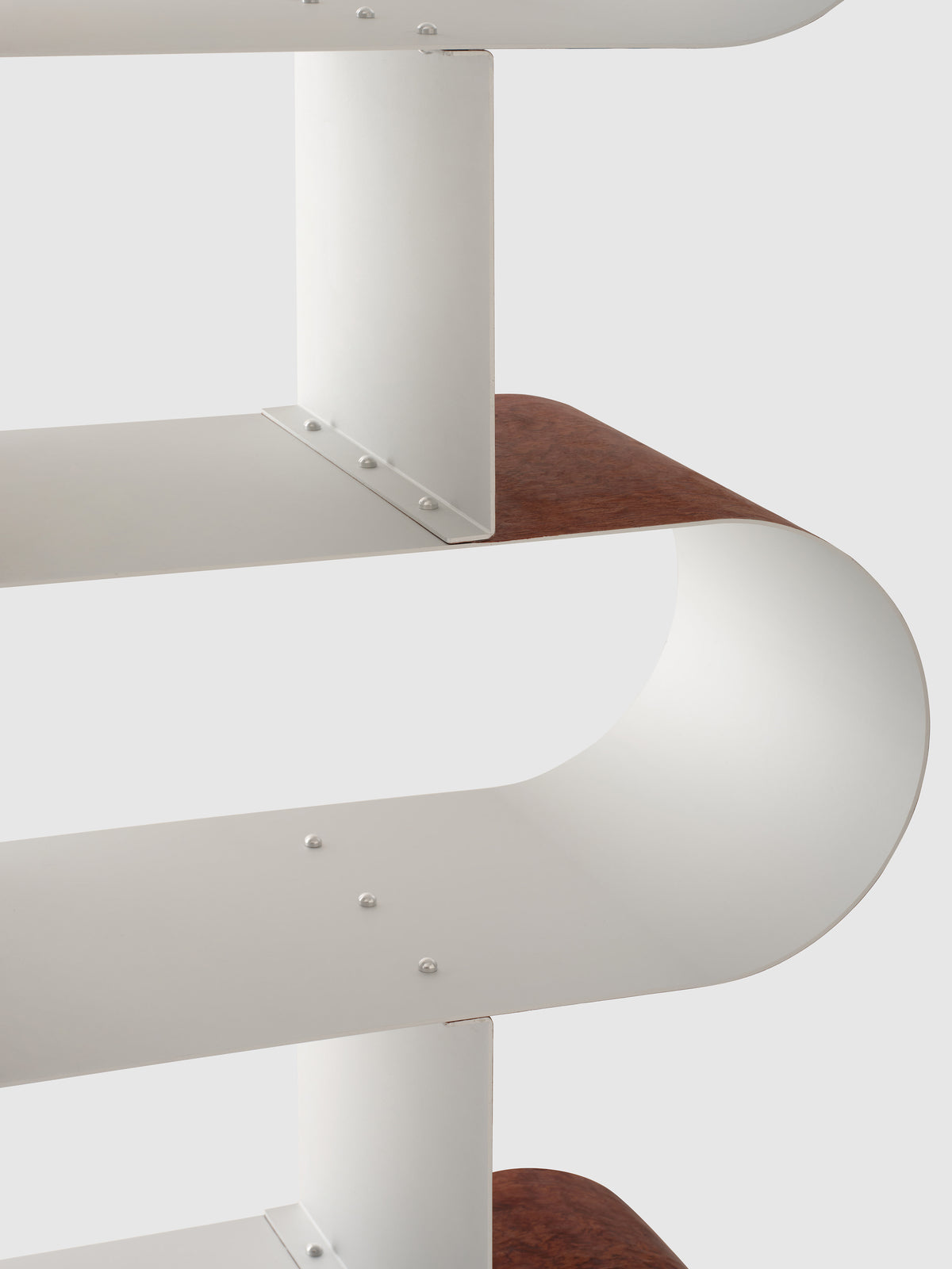 Curved aluminum shelves with wood accent detail by Hun Lee
