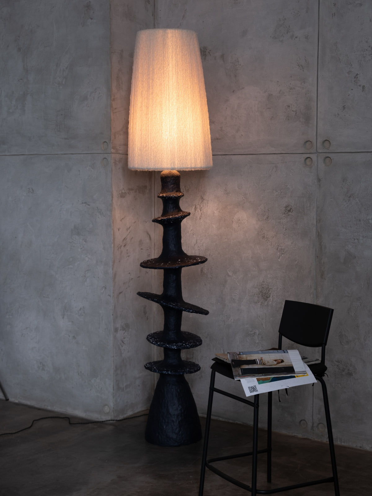 Orbita Floor Lamp — positioned beside a black chair in modern interior