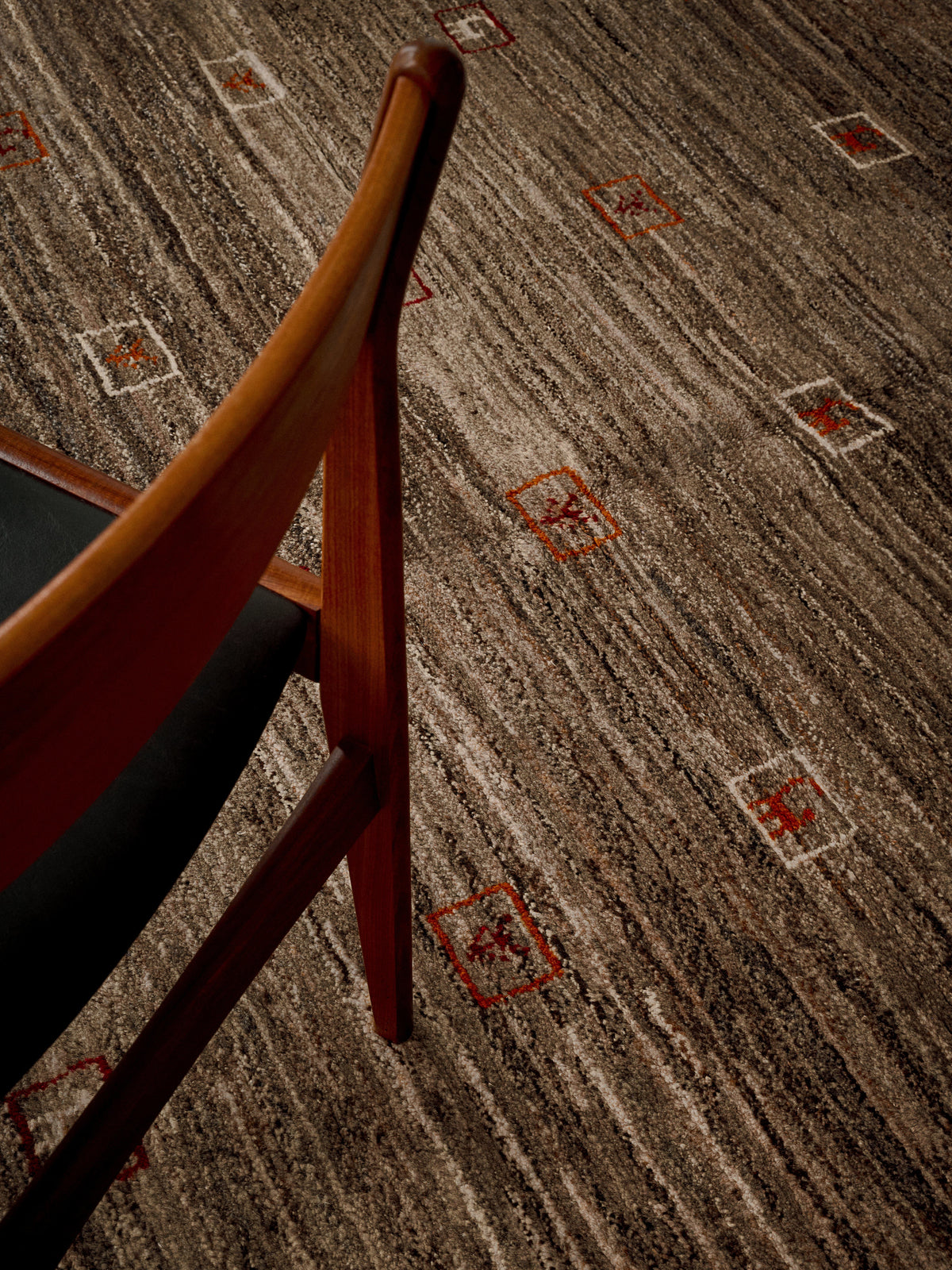 Gabbeh Rug in Sable 173 x 232 cm — side angle showing textured surface and chair