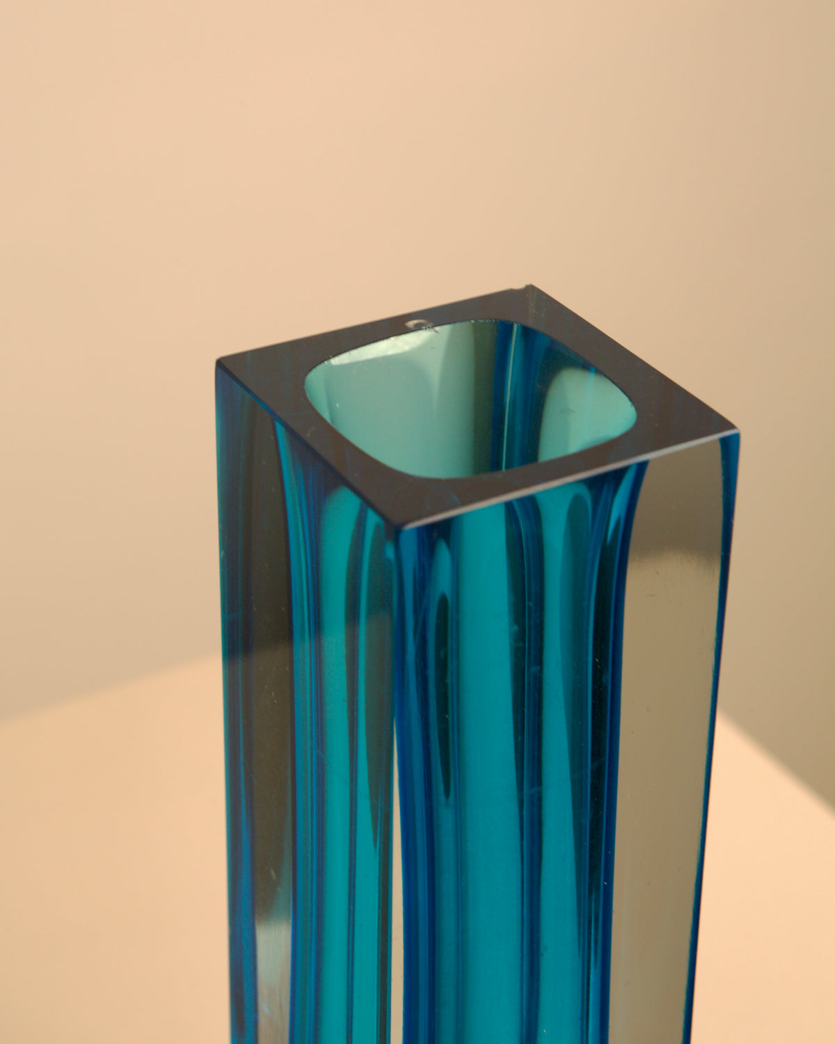 Close-up detail of blue Murano glass vase showing translucent layers
