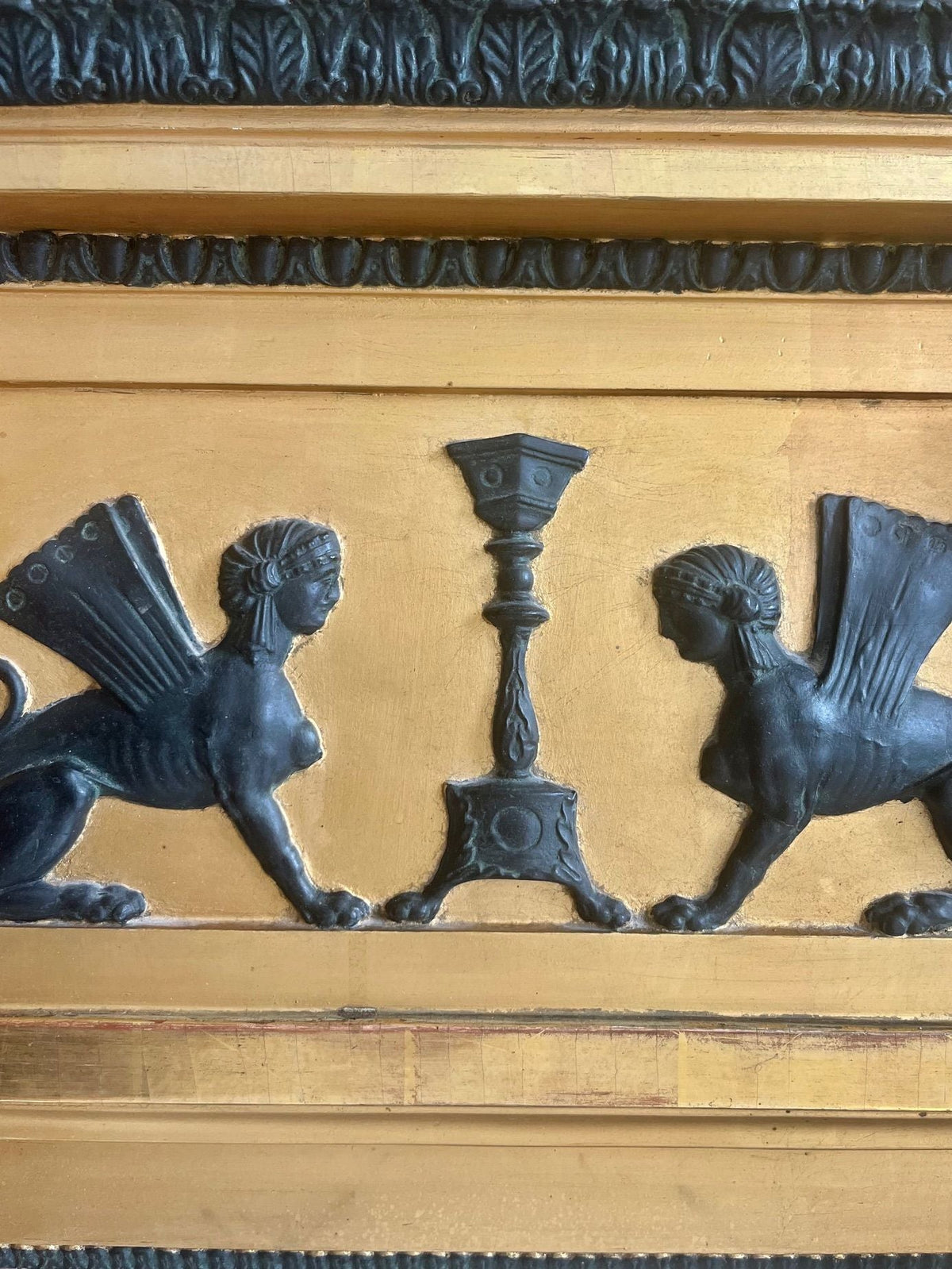 Ornate bronze sphinx details on Gustavian neoclassical mirror frame