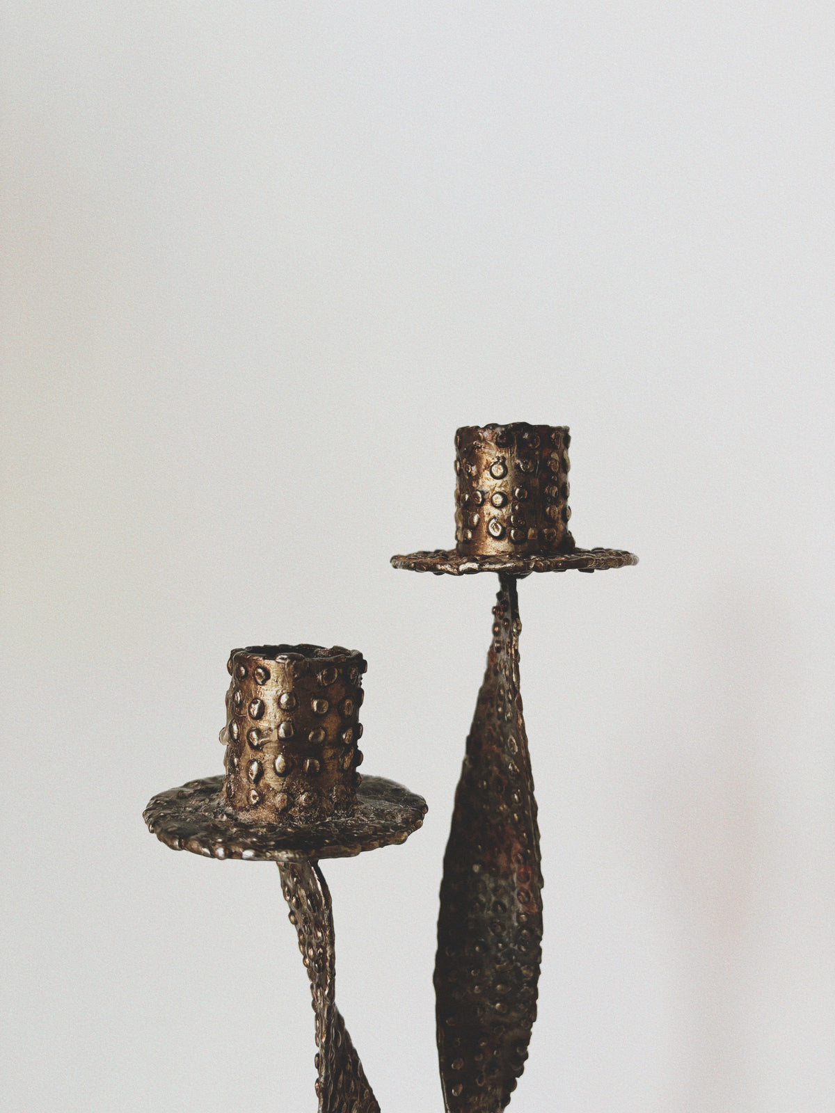Textured Metal 2 Arm Candlestick, Poland — side angle highlighting hammered bronze finish