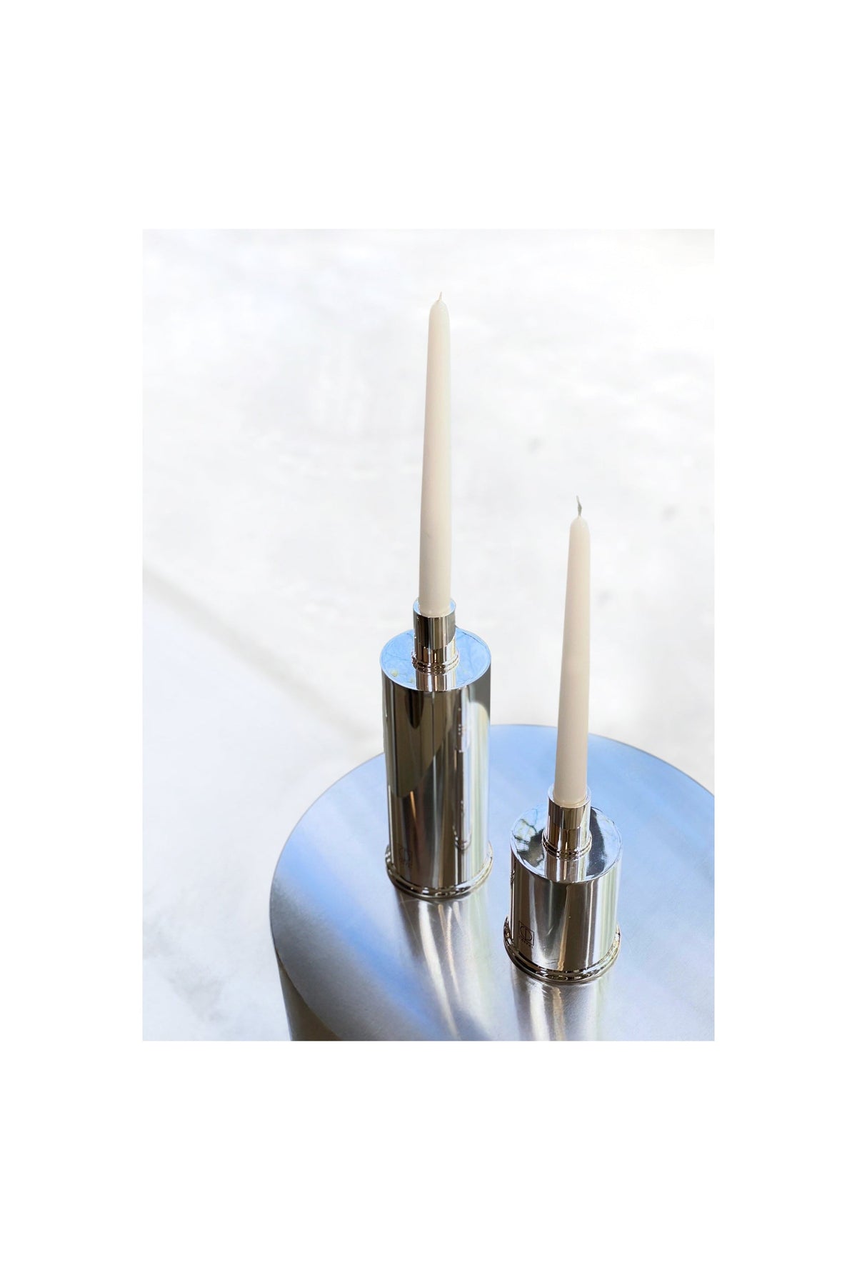 Elegant Candle Holders Silver Plated — angled view on round metallic table