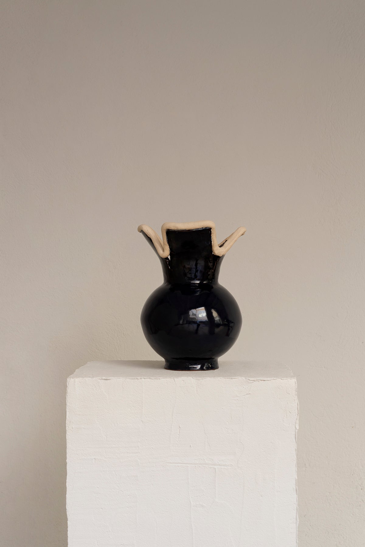 Navy blue glazed ceramic vase with unglazed clay rim detail