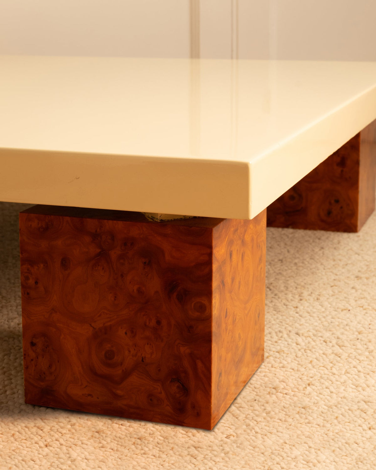 1970s side table detail showing burled wood base and cream lacquered top