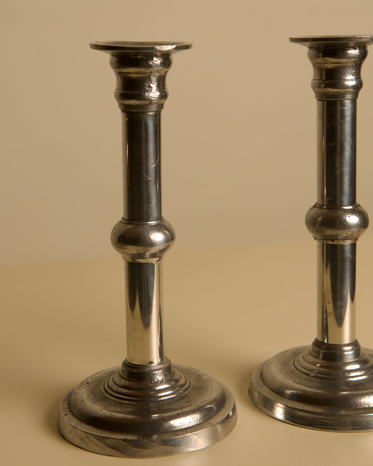 Pair of Italian Metal and Aluminum Candleholdersc80s — side angle showing polished metal finish