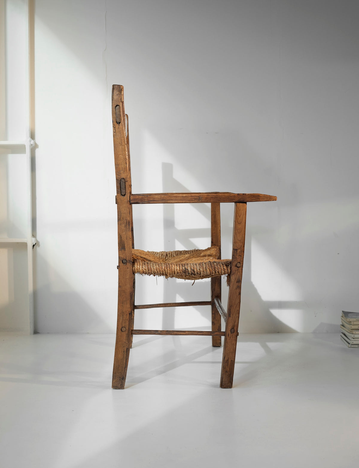 A French folk bench from the 19th Century. Wood and straw — in context
