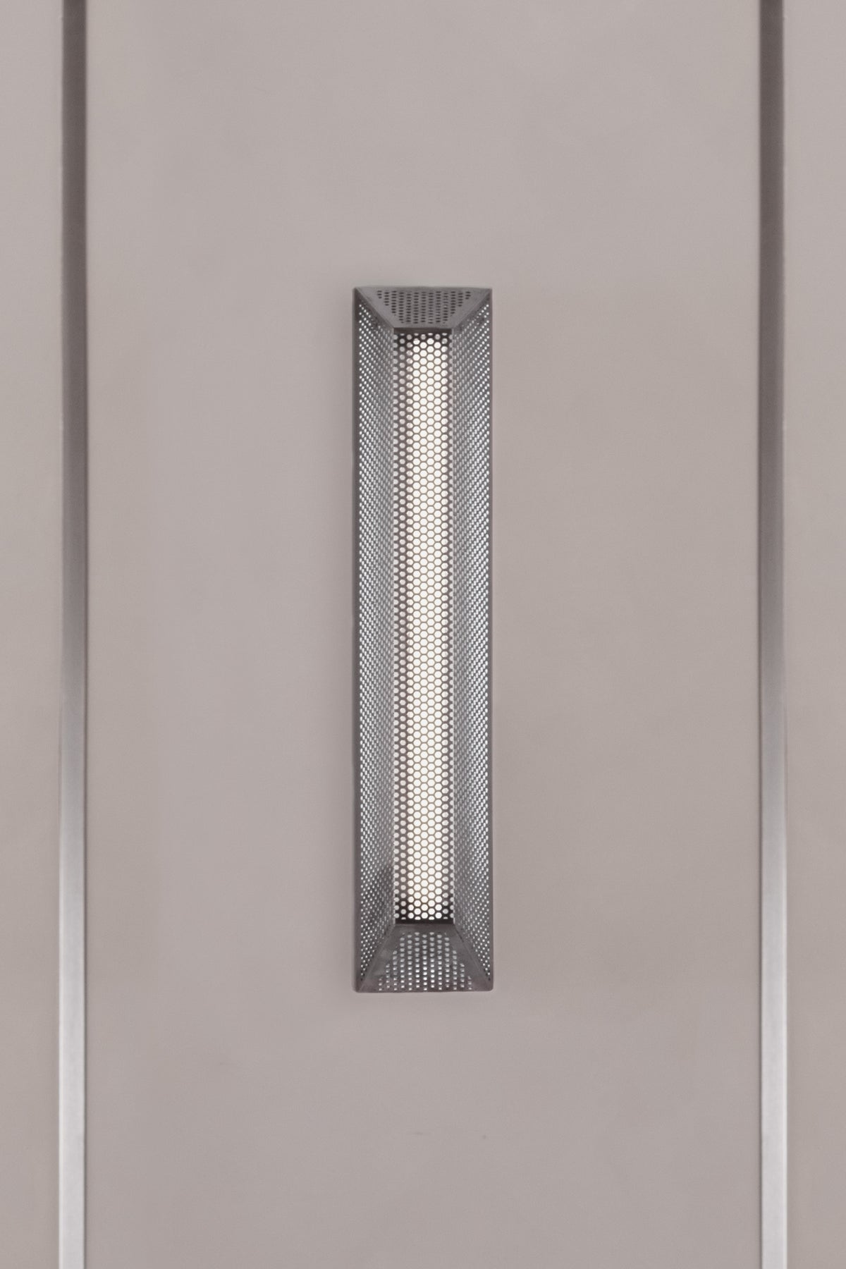 TRAP 50 — close-up of perforated metal wall light