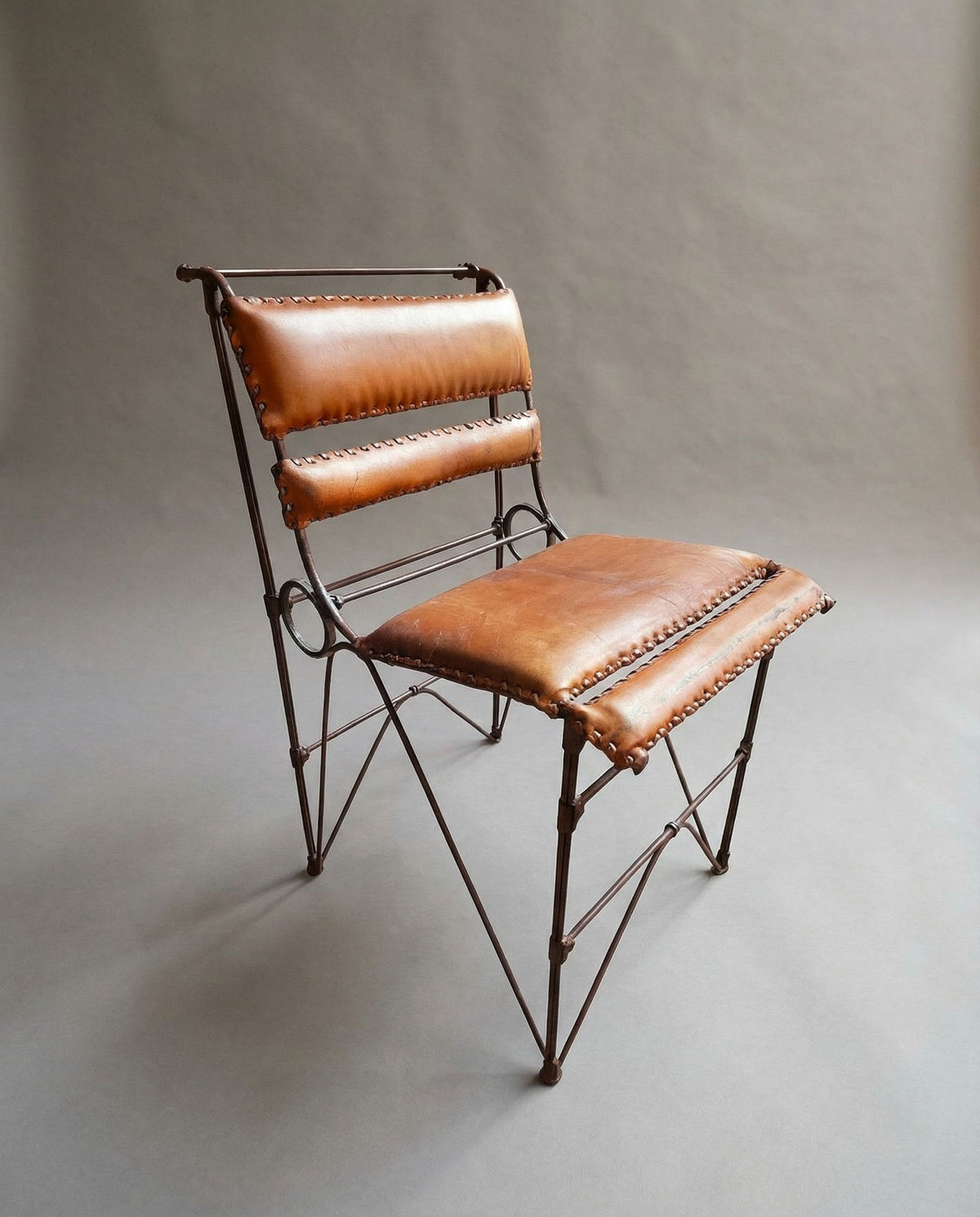 Pair of Brutalist Chairs by Ilana Goor — side view of leather seat and metal frame