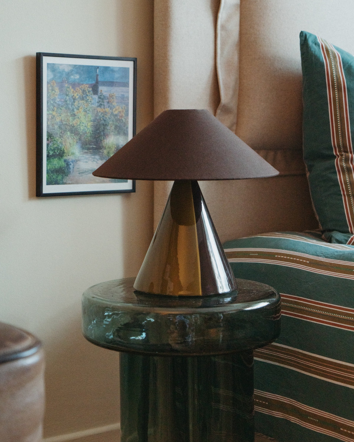 Caterina Table Lamp - Dark Brown from side angle on glass table