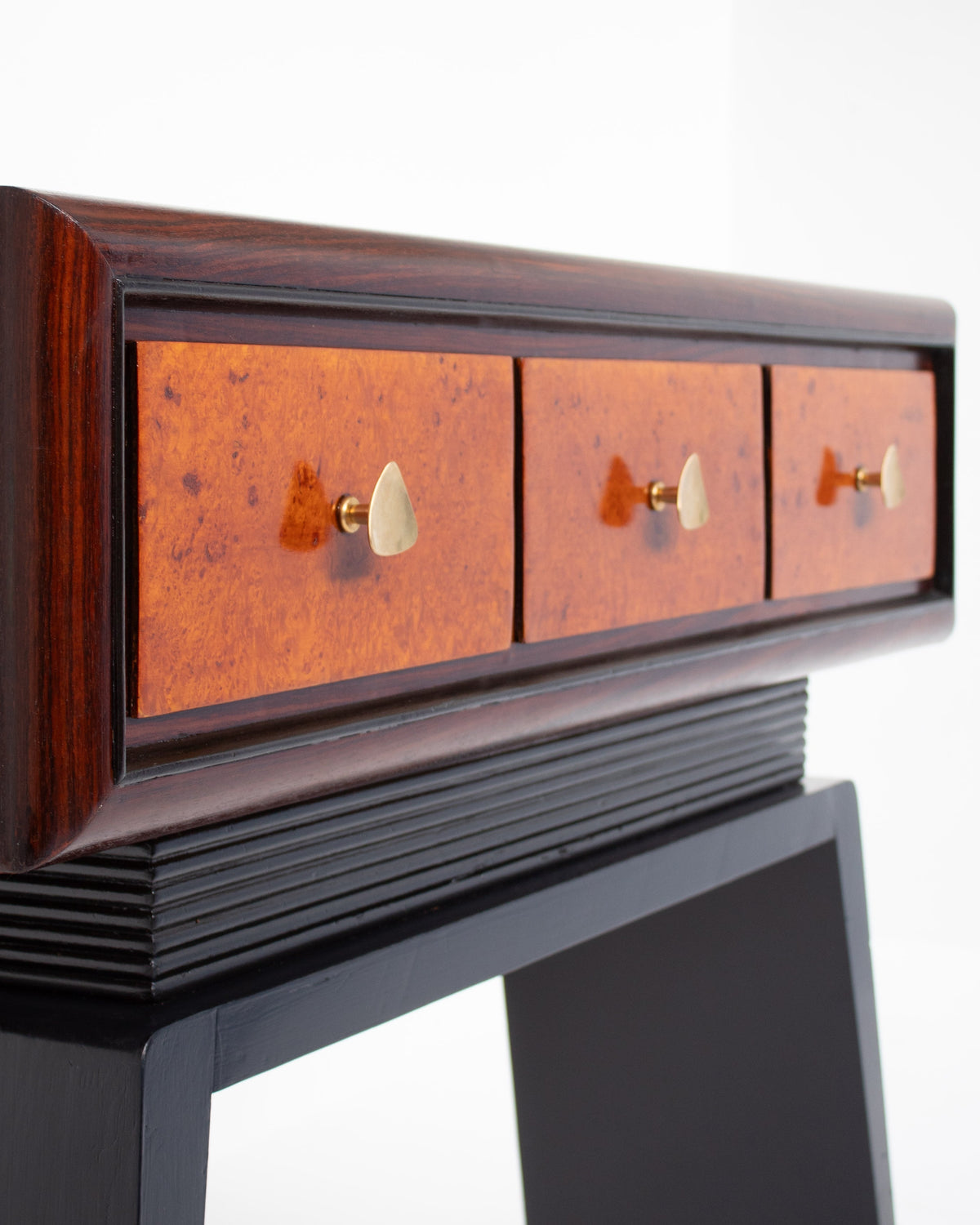 Art Deco console detail showing copper drawer fronts with brass handles