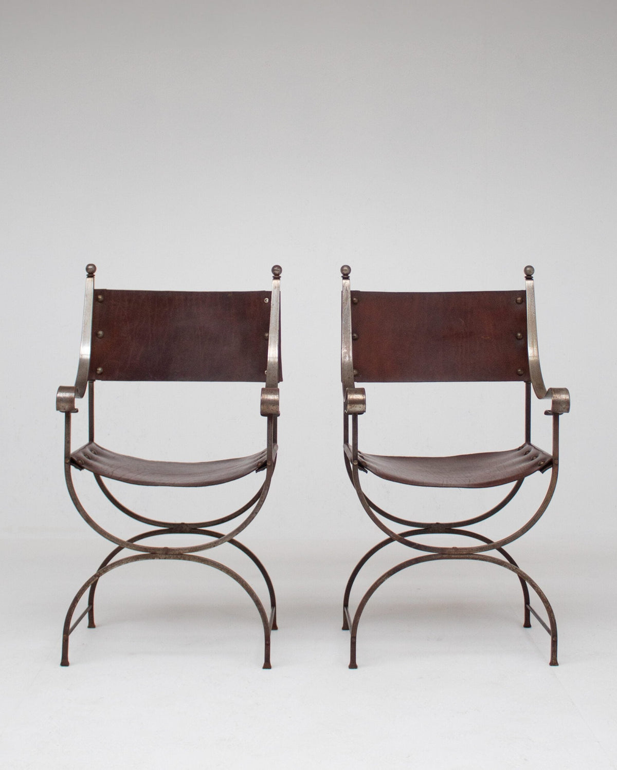 French pair of Iron Curule Chairs in Leather by Malata Antwerp | The Oblist — handcrafted leather, iron frame