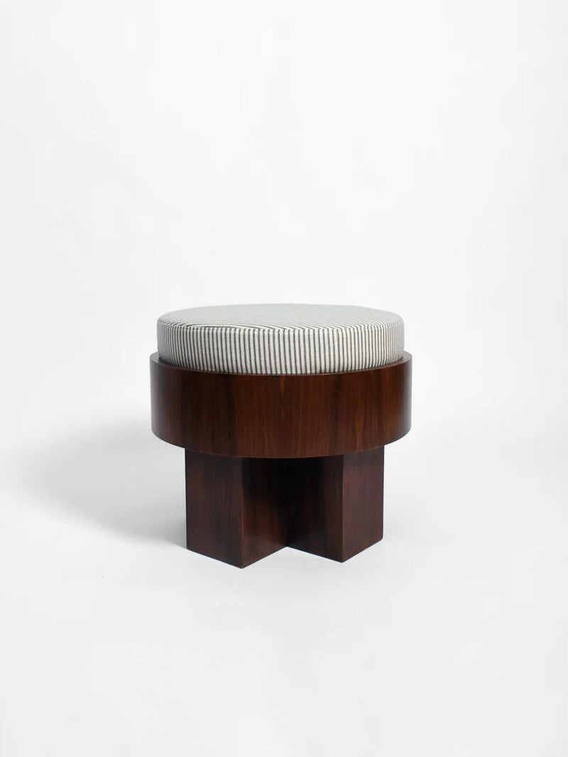 The "Vitruvio" Walnut stool by Barracuda Interiors features a round, cotton striped cushion atop a dark cylindrical walnut base with four intersecting legs. Expertly crafted in Portugal and shown against a plain white background.