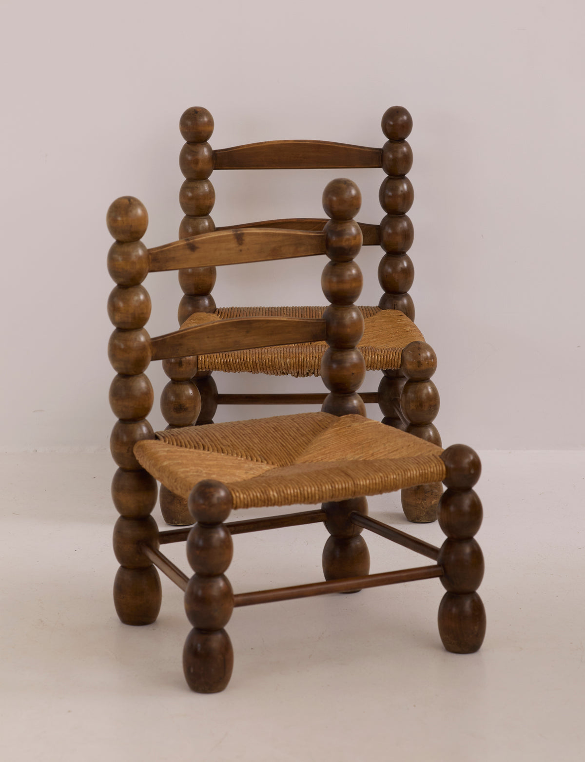 Vintage French Oak Wood and Straw Low Chair C. 1940 — side angle showing round wooden legs and woven seat