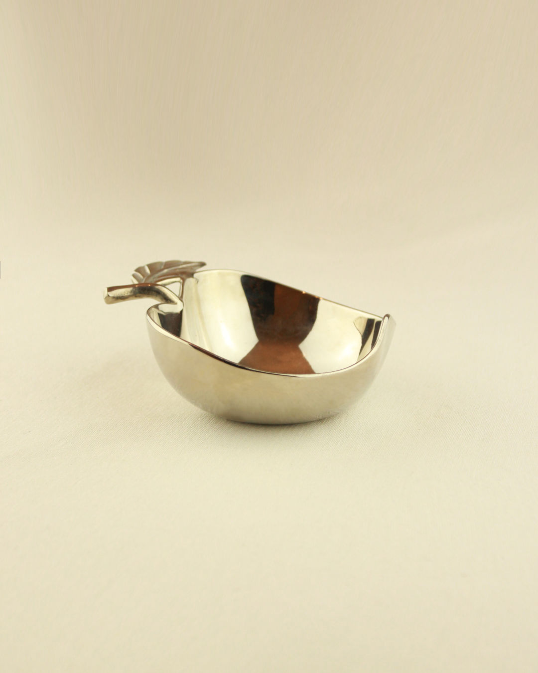 The Decorative Apple Shaped Dish by Boga Avante Shop is a small, shiny vintage brass bowl featuring a smooth, reflective finish—perfect for displaying treats or trinkets on any surface.