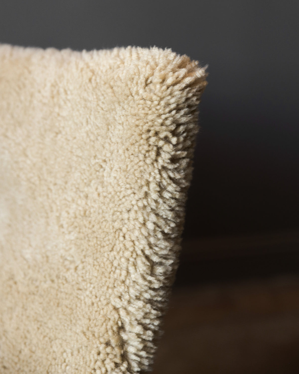 A close-up of soft beige shearling fabric evokes the luxurious comfort of the Pair of PK20 Chairs by Poul Kjaerholm in Shearling, offered by Studio OSKLO.