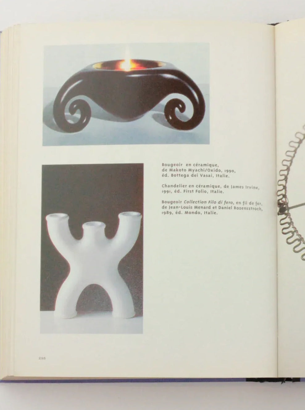 An open Objets Affectifs: Le Nouveau Design de la Table by Boga Avante Shop displays two images and text on the left page. The top image shows a black ceramic candle holder with a swirling design. The bottom image presents a white ceramic candle holder with a unique shape resembling three interconnected tubes, showcasing an exquisite diseño moderno.