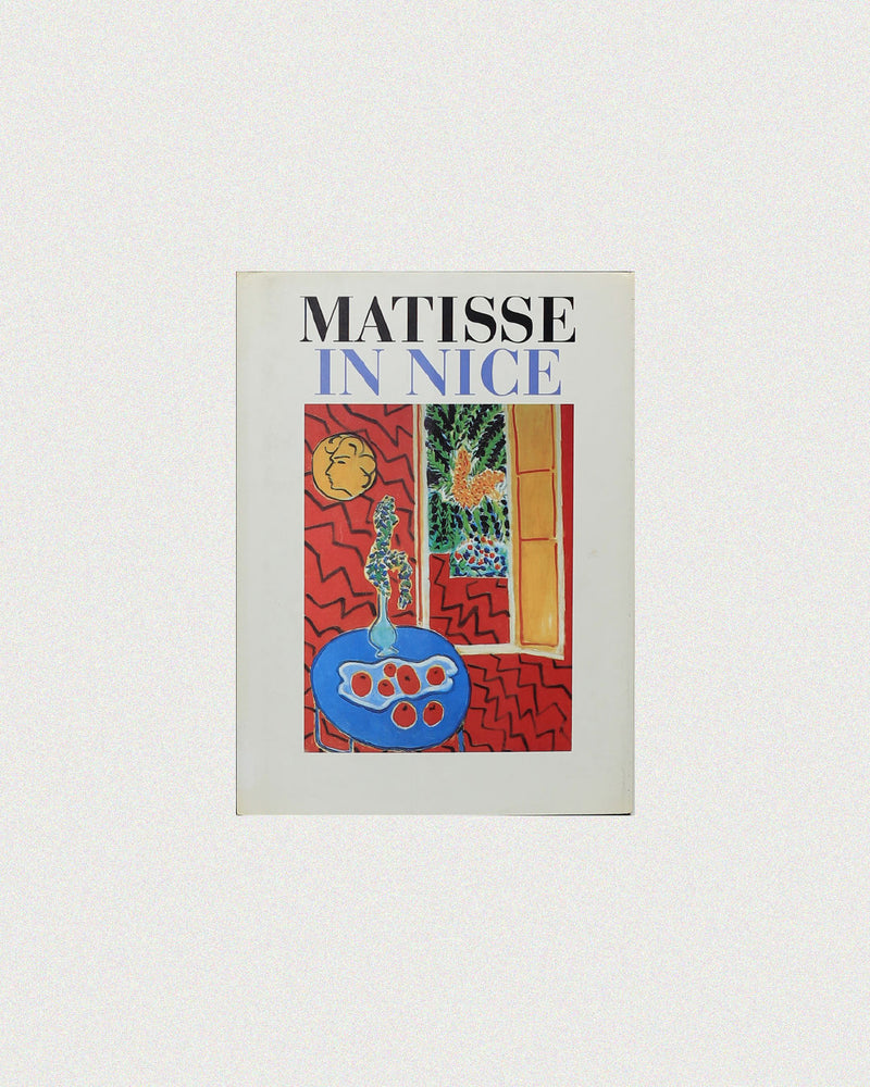 The 'Matisse in Nice' Book by Boga Avante Shop features a vibrant cover with a red table, blue vase with green leaves, and abstract yellow and red shapes, capturing the colorful, lively spirit of southern France inspired by Matisse.