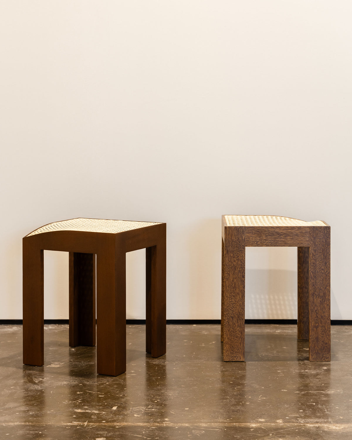 Two Canto wooden stools with woven cane tops by Andre Grippi