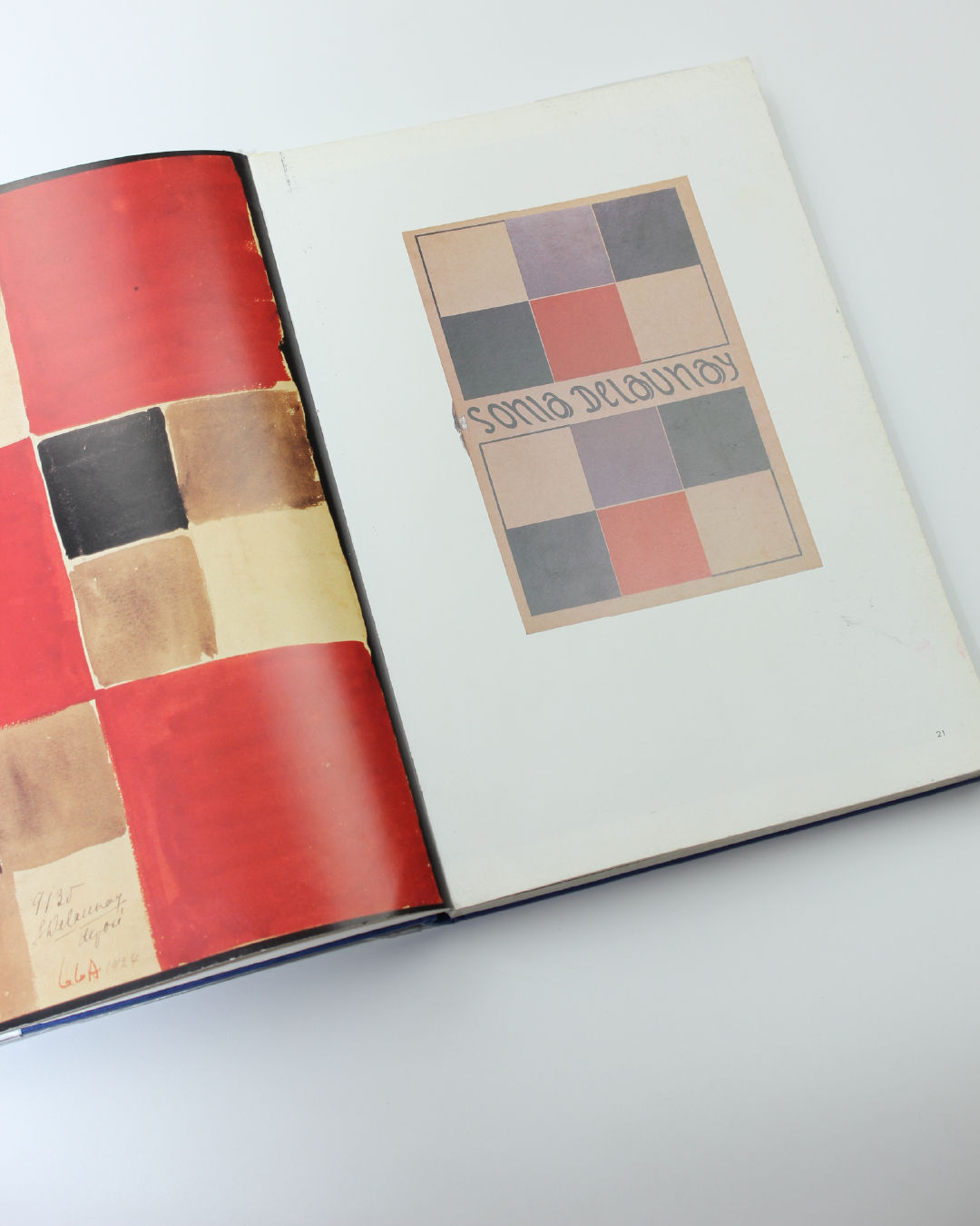 Open Sonia Delaunay book showing geometric color fabric patterns