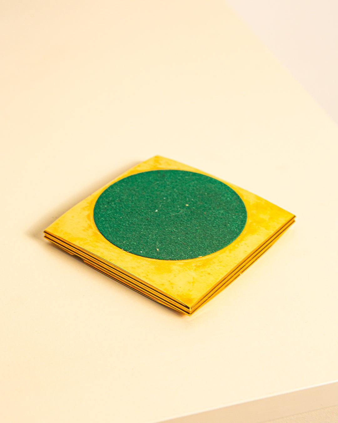The Brass Ashtray by Francois Gross 60's from Treaptyque, featuring a bold design, rests on a light surface, capturing the playful spirit of 60s style.