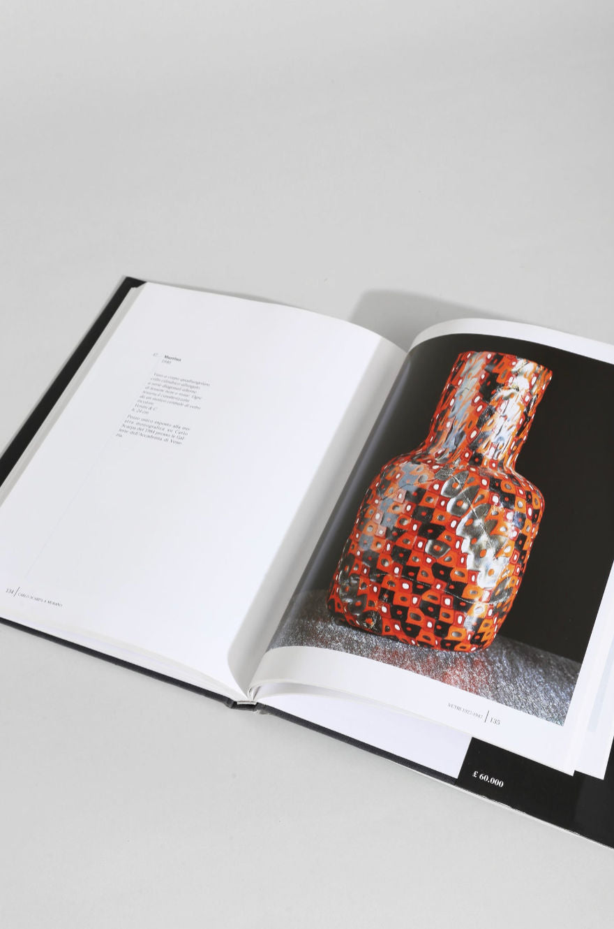 Open Carlo Scarpa Murano glass book showing colorful mosaic vase