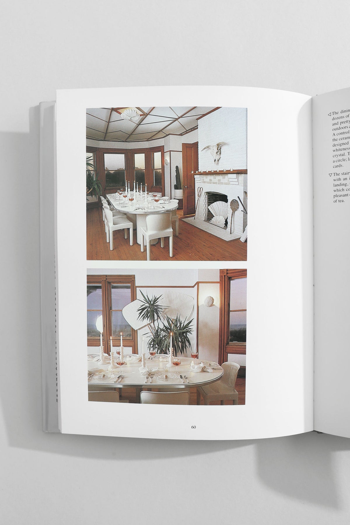Open design book showing two dining room interior spreads with modern furniture