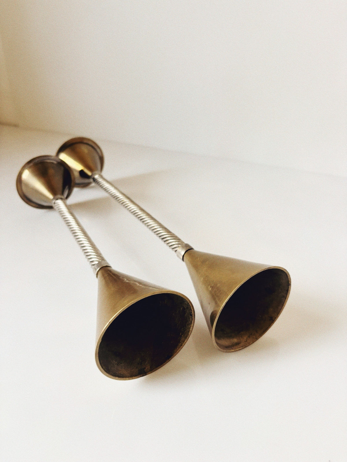 Brass candleholders with twisted stems detail view