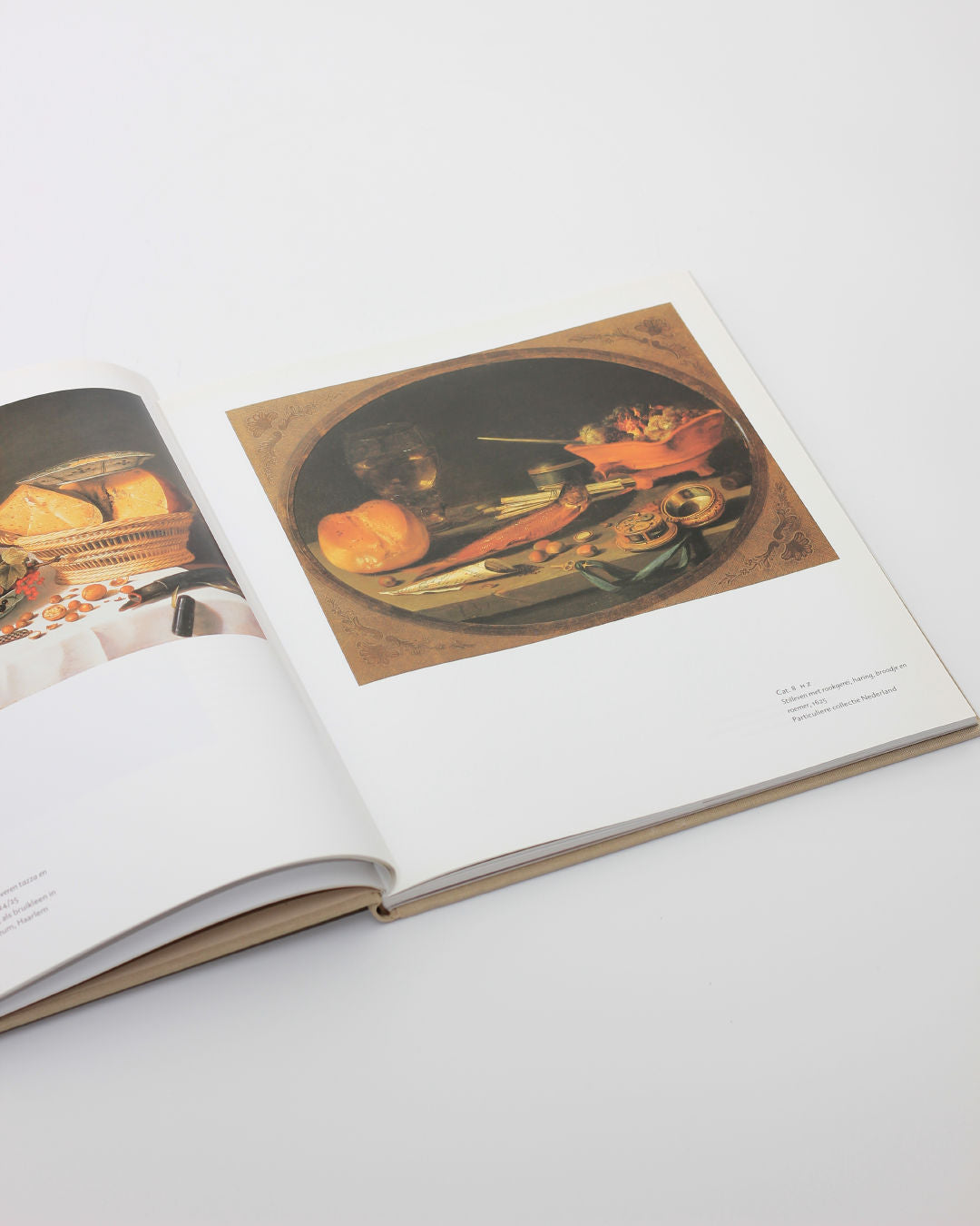 Open Pieter Claesz art book showing Dutch still life painting detail