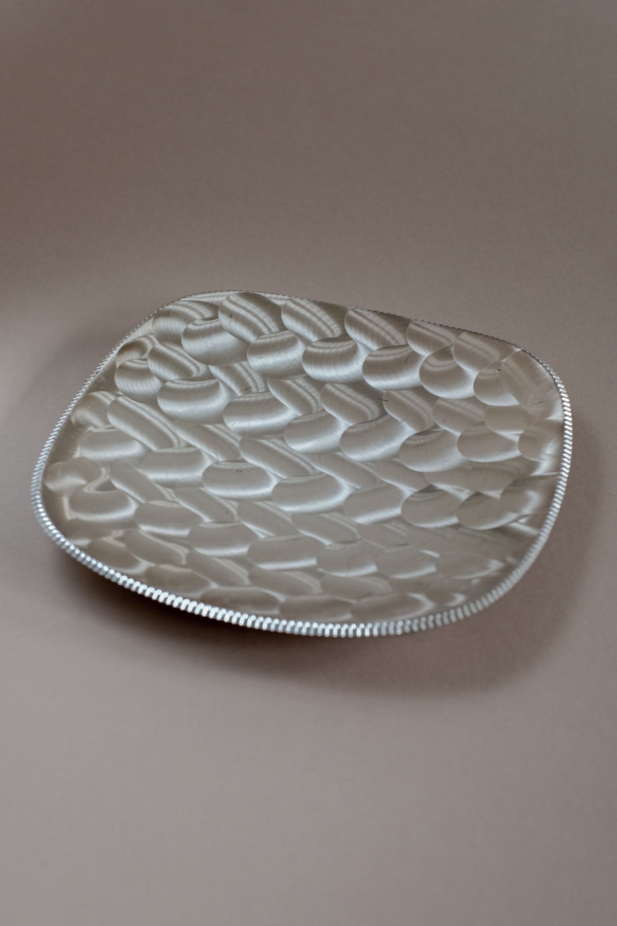 Silver-plated dish with textured honeycomb pattern surface detail