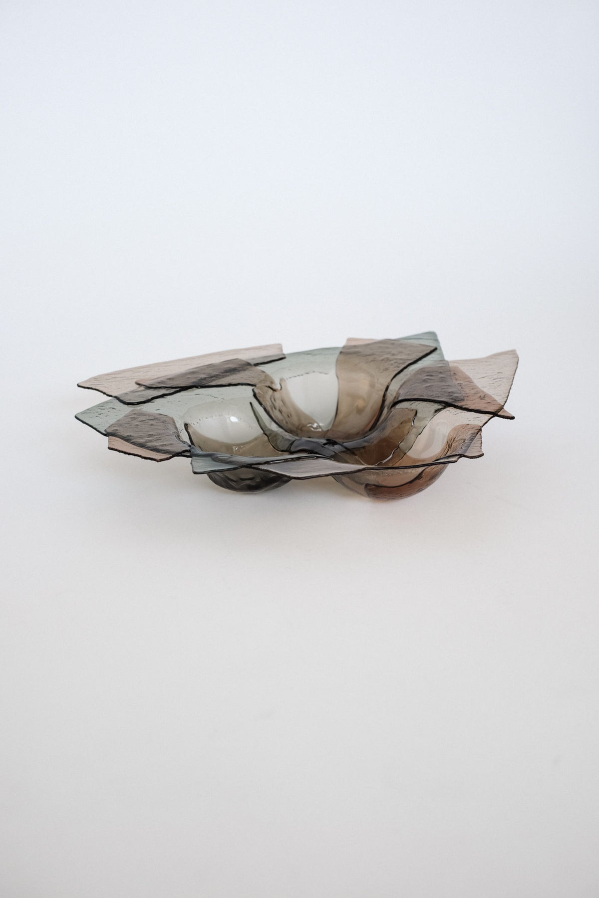 Sculptural smoked glass bowl with organic petal-like edges