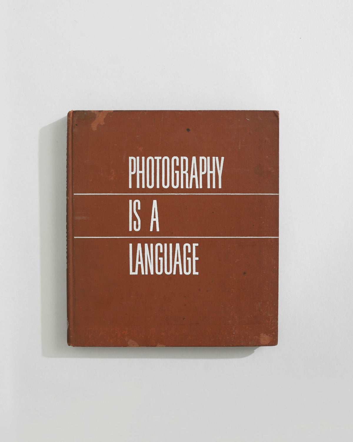 Photography is a Language hardcover book with brown cover