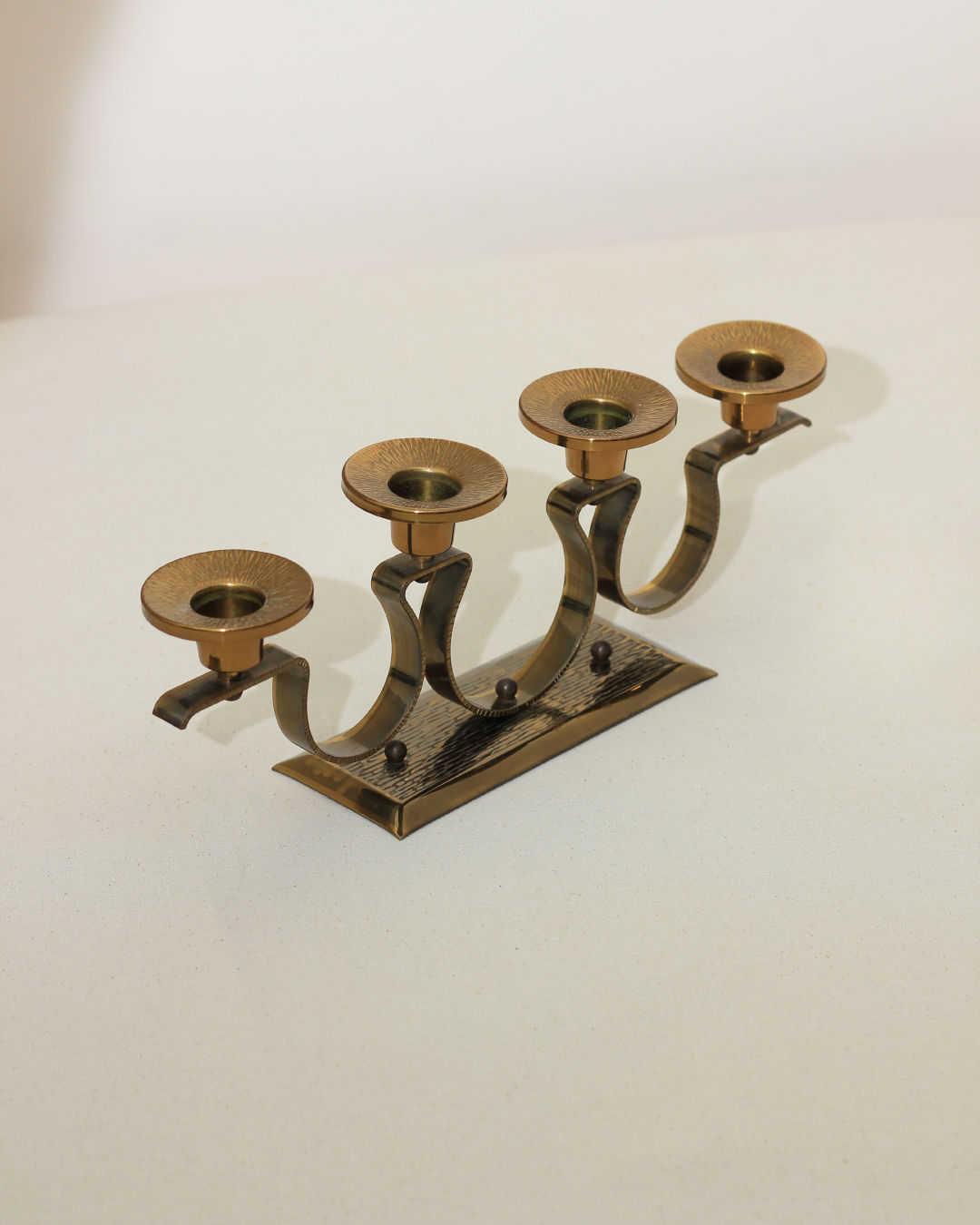 Mid-century brass candelabra with curved arms for four candles