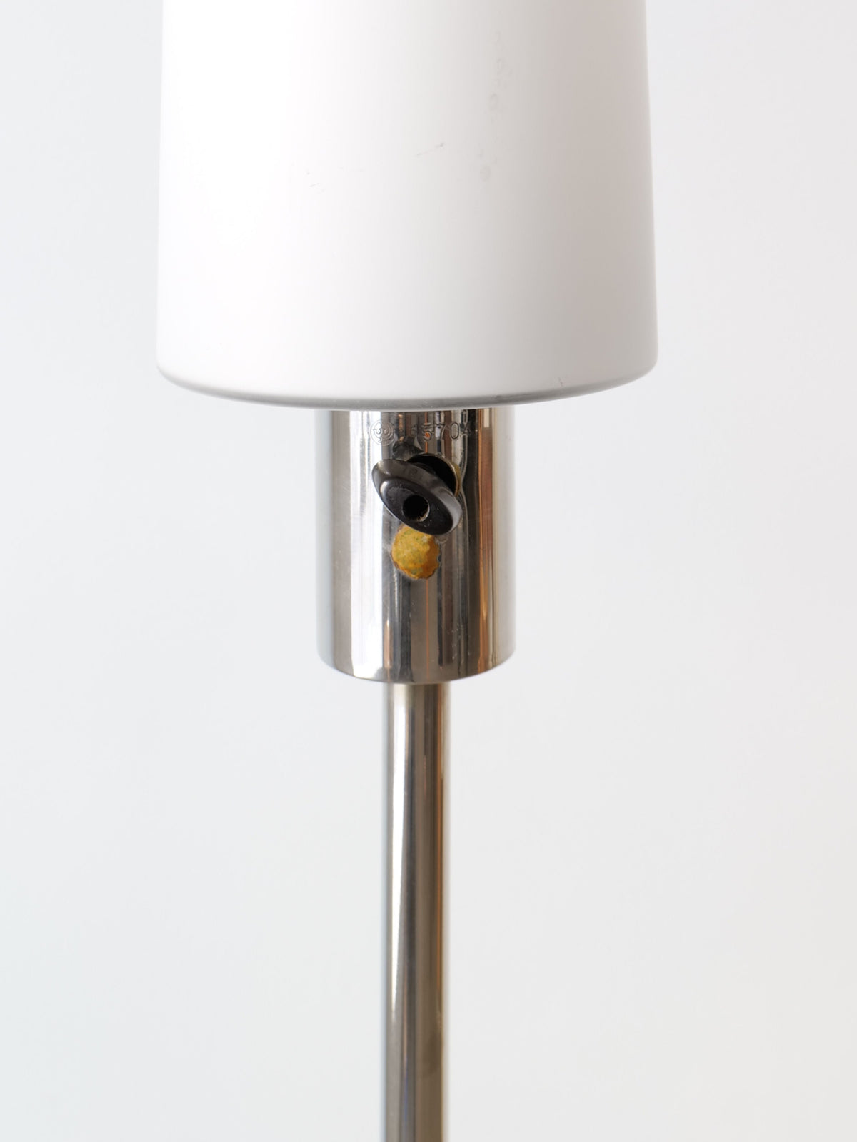 A close-up of the Collection apart Deco Floor Lamp Harald Notini 1940s, featuring a silver base, black rotary switch, and white lampshade, set against a plain white background.