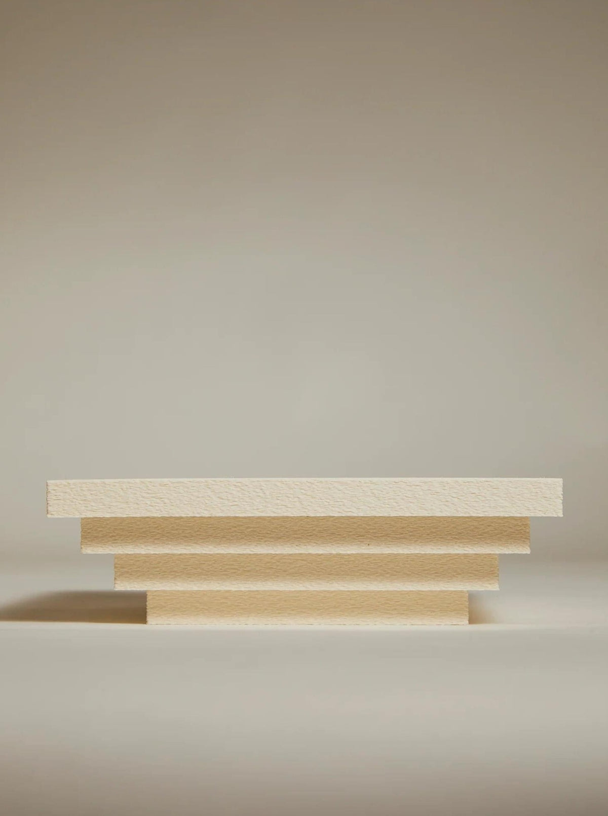 The Bau Bowl from Argot Studio features a minimalist, sculptural design with horizontal tiers against a plain background. This contemporary piece creates a stepped appearance that evokes symmetry and balance, making it perfect for luxury interiors.