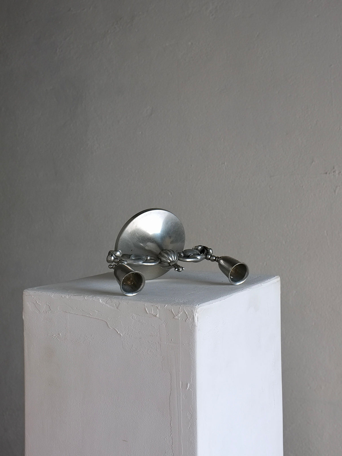 Swedish Grace pewter candleholder displaying ornate sculptural base