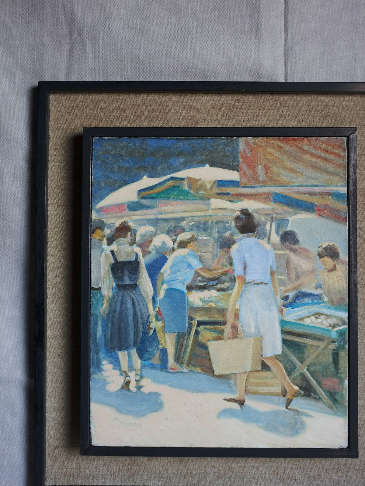 The "Vintage Genre Oil Painting with Market Scenes" by Veter Vintage vividly portrays a bustling summer market day where people are engaging in various activities. Some individuals are browsing goods on tables under colorful umbrellas while others meander around. The painting's dominant hues of blue, white, and earth tones capture a lively outdoor atmosphere.