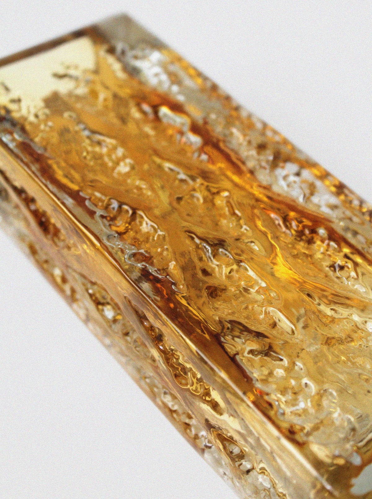 Amber crystal glass vase detail showing swirled texture patterns